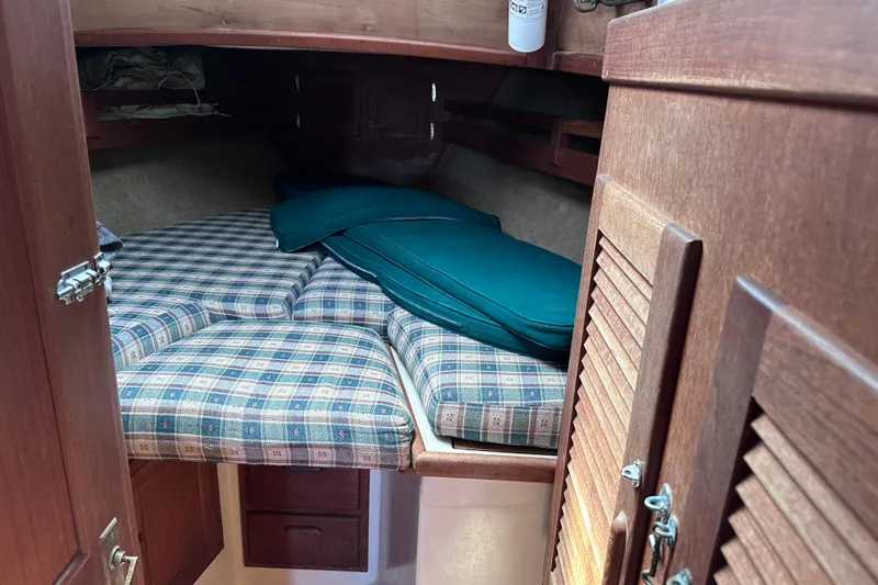 Slide: The Image of Cozy cabin interior of 1986 Pacific Seacraft 34 sailboat with plaid cushions. - 55