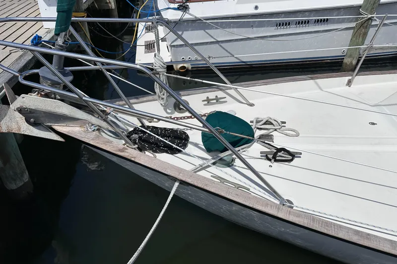 Slide: The Image of Bow of 1986 Pacific Seacraft 34 sailboat docked, featuring anchor and ropes. - 6