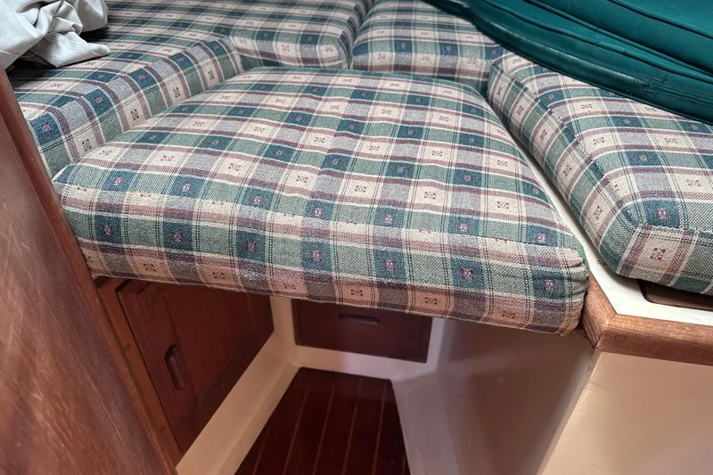Slide: The Image of Plaid-patterned cushions in the cabin of a 1986 Pacific Seacraft 34 sailboat. - 60