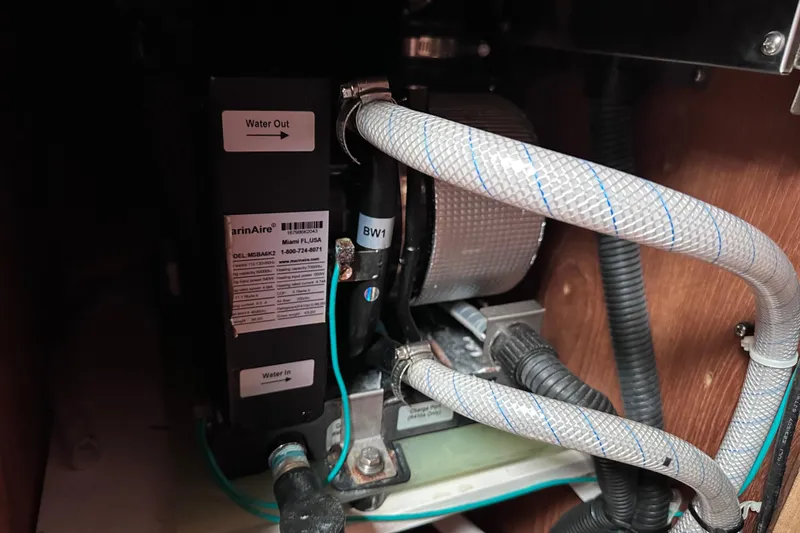 Slide: The Image of Marine air conditioning unit in a 1986 Pacific Seacraft 34 sailboat, showing water connections. - 62