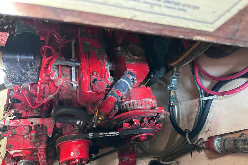 Slide: The Image of Engine compartment of a 1986 Pacific Seacraft 34 sailboat, featuring red mechanical components. - 65