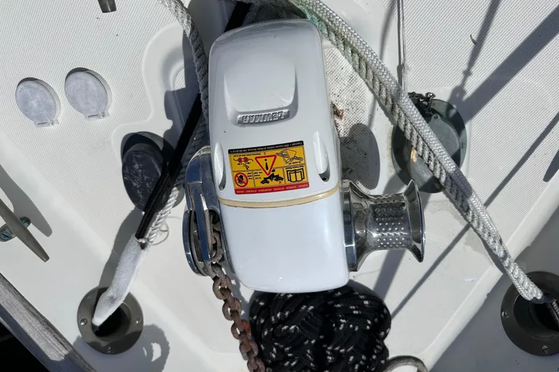 Slide: The Image of Windlass on 1986 Pacific Seacraft 34 sailboat deck with ropes and chains. - 9