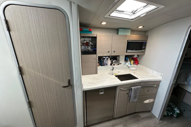 Slide: The Image of Interior of 2019 Formula 37 Performance Cruiser kitchen with modern amenities and sleek design. - 26