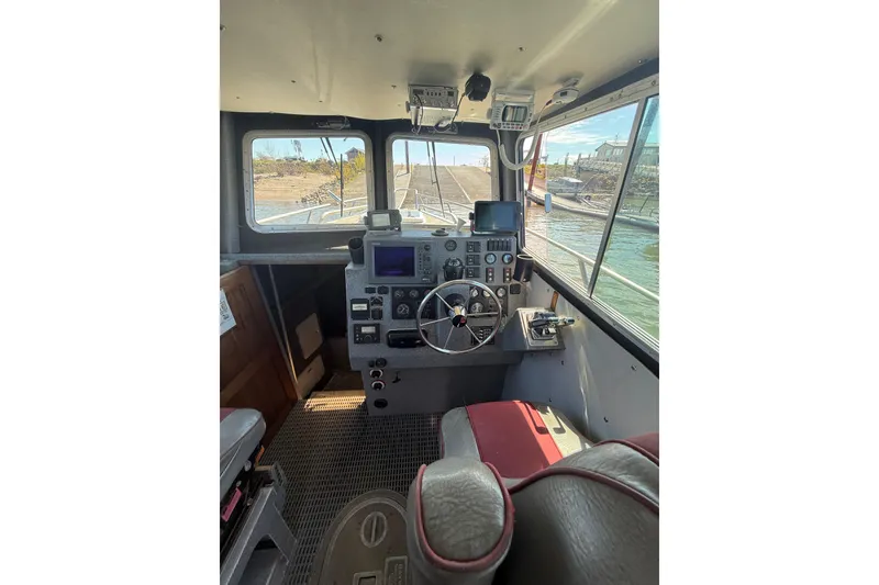 Slide: The Image of Interior of a 2004 Norsco 28 boat cockpit with steering wheel and control panel. - 11
