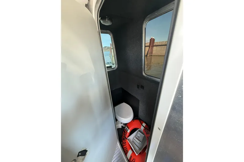 Slide: The Image of Compact boat interior with toilet and life preserver, Norsco 28, 2004 model. - 15