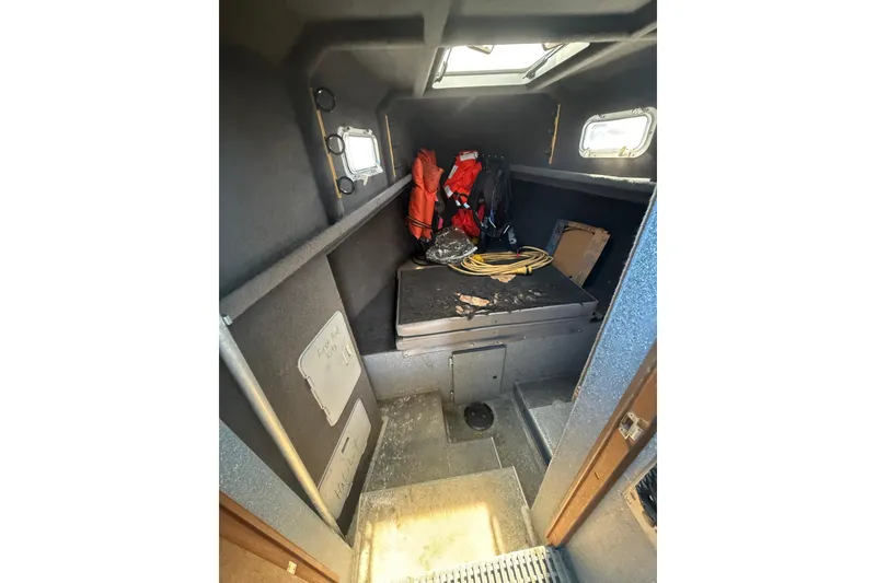 Slide: The Image of Interior cabin of a 2004 Norsco 28 boat with storage and equipment. - 16