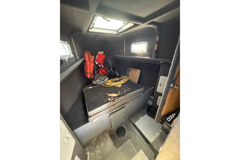 Slide: The Image of Interior of a 2004 Norsco 28 boat with life jackets and equipment. - 17