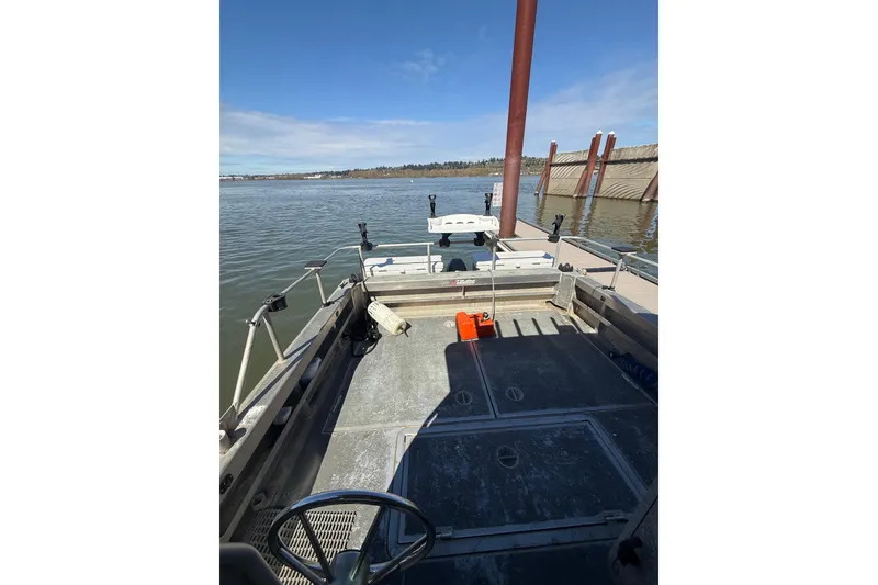 Slide: The Image of 2004 Norsco 28 boat docked on a calm river under a clear blue sky. - 21