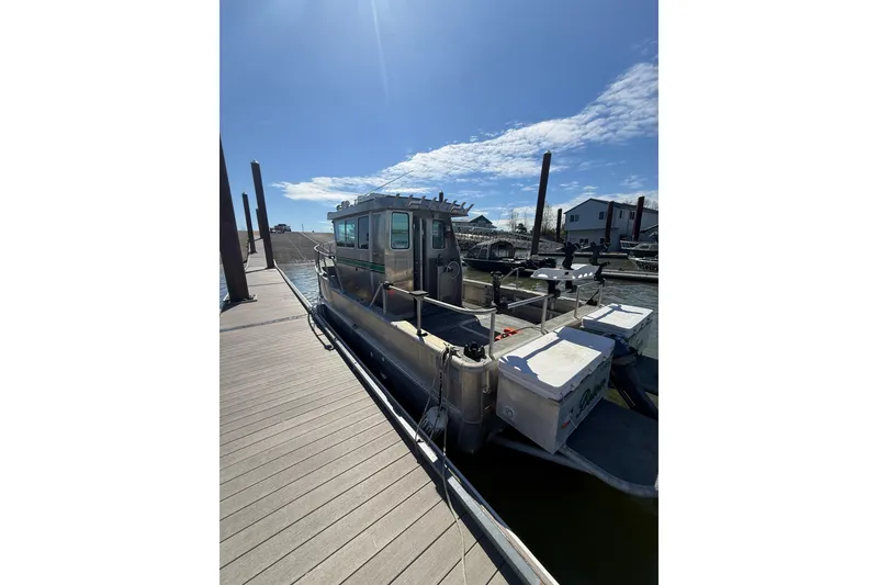 Slide: The Image of 2004 Norsco 28 boat docked under clear blue sky. - 4