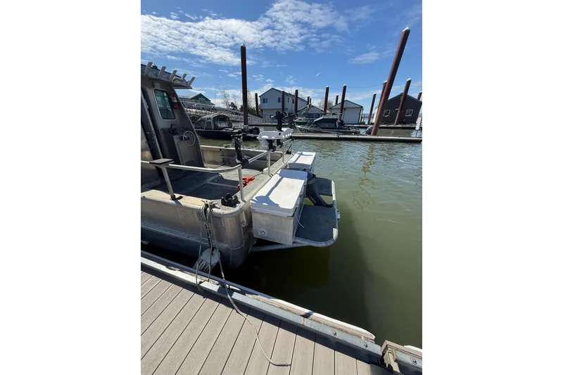 Slide: The Image of Boat docked at marina, Norsco 28 model, 2004, with clear sky and waterfront view. - 5