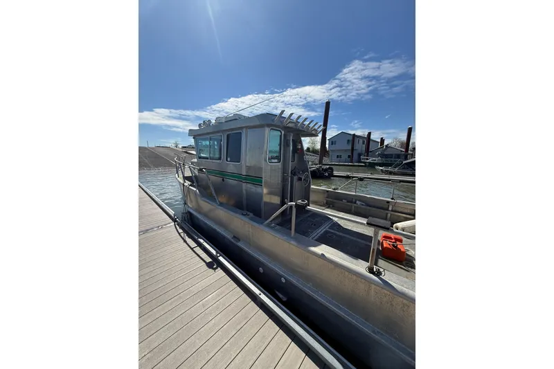 Slide: The Image of 2004 Norsco 28 boat docked under clear blue sky. - 6