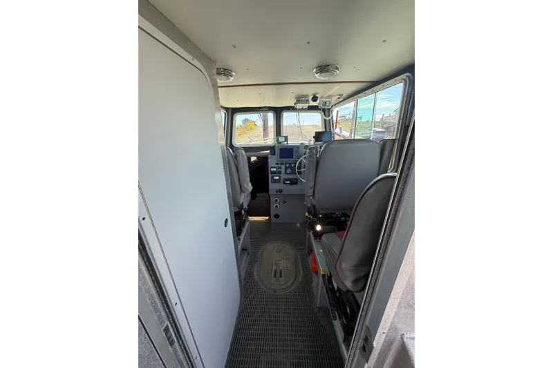 Slide: The Image of Interior of a 2004 Norsco 28 vehicle cockpit with control panel and seating. - 9