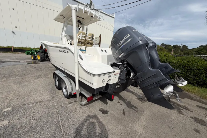 Slide: The Image of 2015 Sea Fox 266 Commander boat with dual Yamaha engines on a trailer. - 11