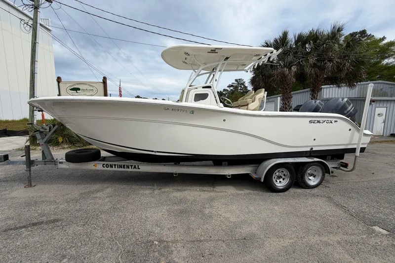 Slide: The Image of 2015 Sea Fox 266 Commander boat on trailer, parked outdoors. - 2