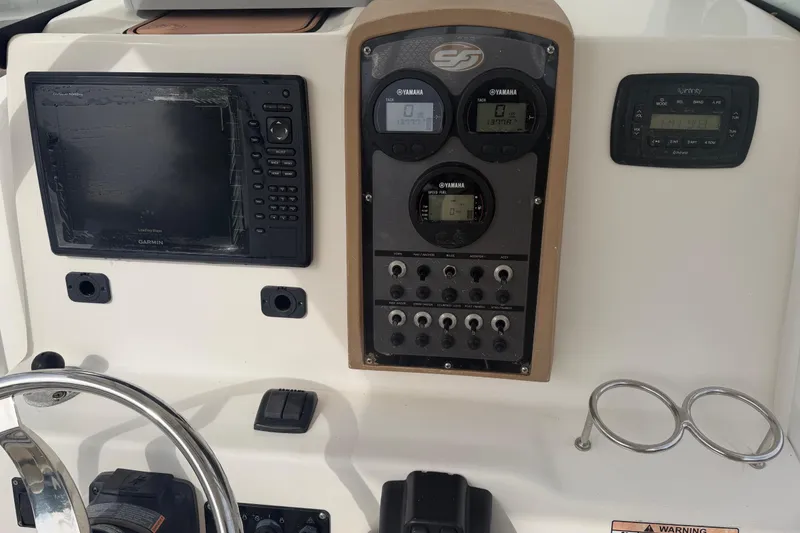 Slide: The Image of Control panel of a 2015 Sea Fox 266 Commander boat with Garmin and Yamaha displays. - 29