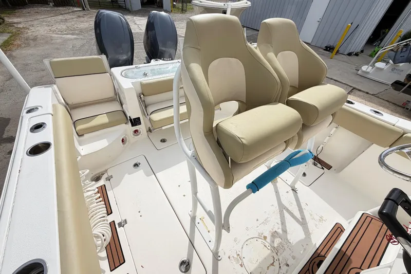 Slide: The Image of 2015 Sea Fox 266 Commander boat interior with beige seating and dual engines. - 41