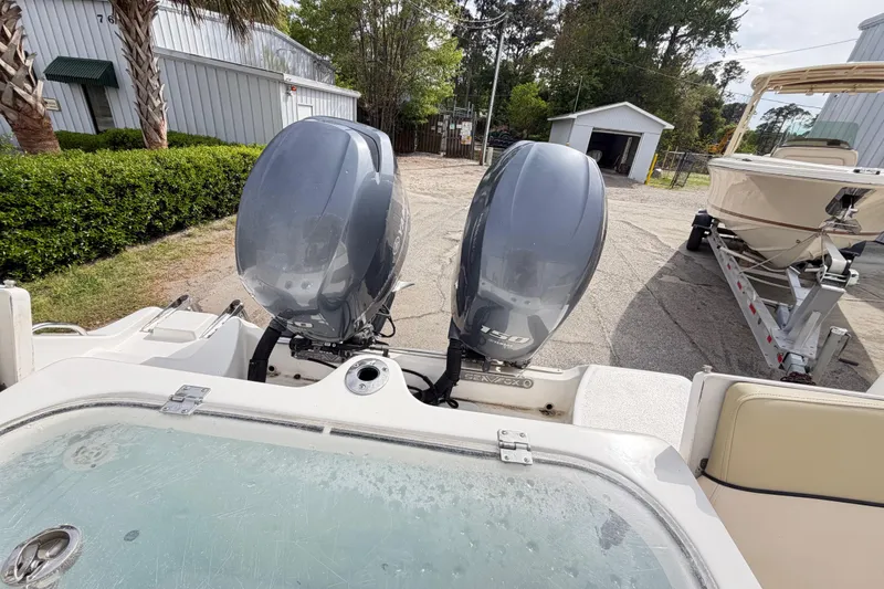 Slide: The Image of 2015 Sea Fox 266 Commander with dual outboard engines, parked near a trailer. - 42