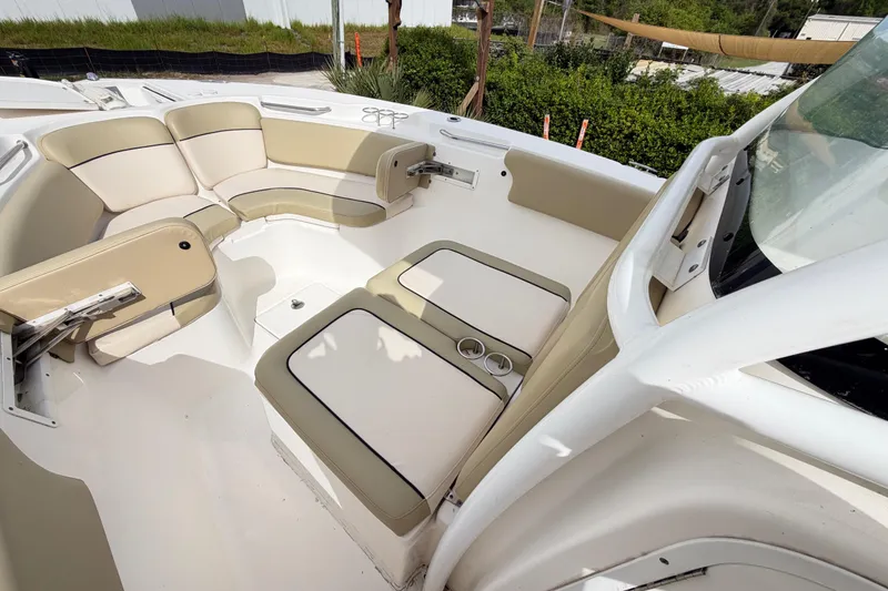 Slide: The Image of Interior seating of a 2015 Sea Fox 266 Commander boat, featuring beige upholstery. - 45