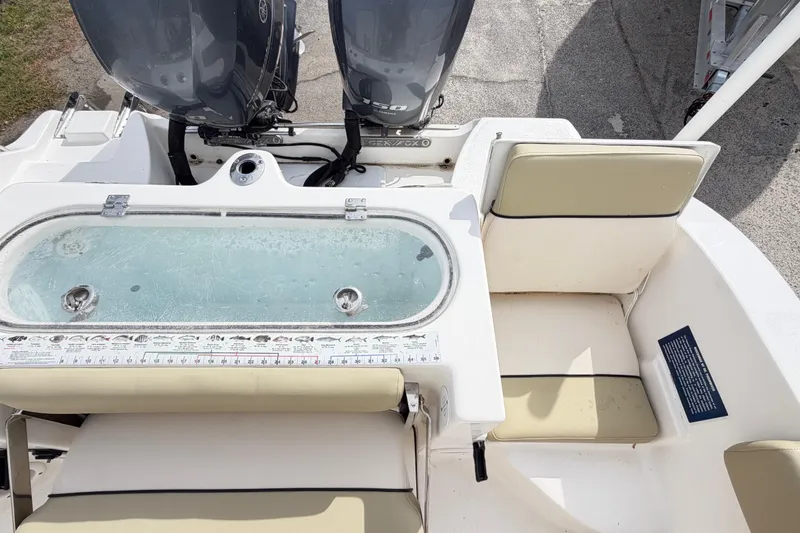 Slide: The Image of 2015 Sea Fox 266 Commander boat interior with dual engines and seating area. - 47