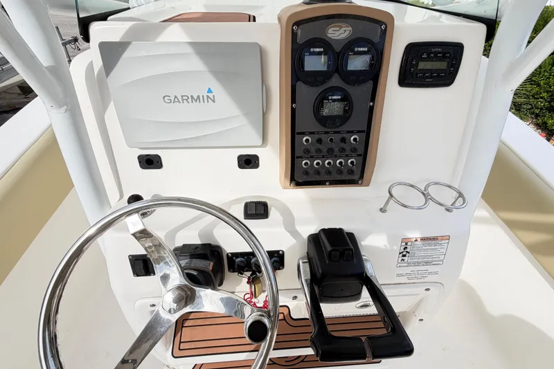 Slide: The Image of 2015 Sea Fox 266 Commander boat dashboard with Garmin navigation and Yamaha controls. - 48