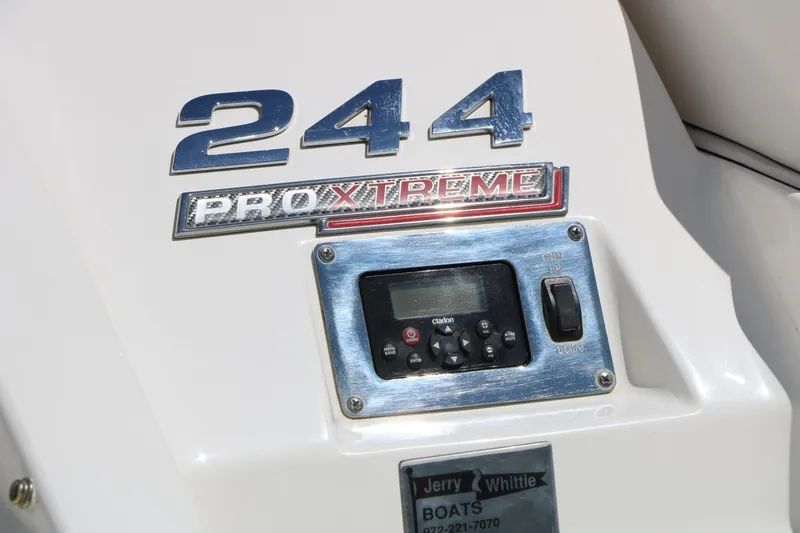 Slide: The Image of 2014 Chaparral 244 Xtreme boat dashboard with control panel and branding. - 11