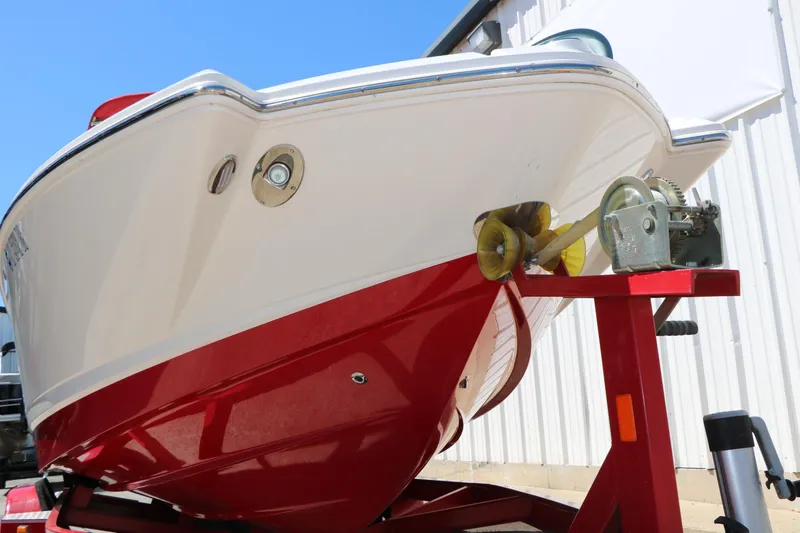 Slide: The Image of 2014 Chaparral 244 Xtreme boat on trailer, red and white hull, sunny day. - 14