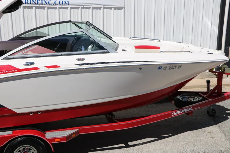 Slide: The Image of 2014 Chaparral 244 Xtreme boat on red trailer, parked outdoors. - 19