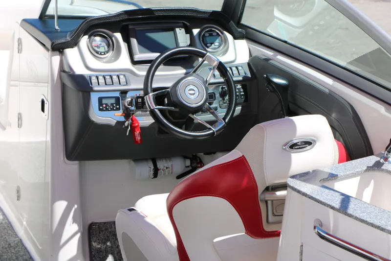 Slide: The Image of 2014 Chaparral 244 Xtreme boat cockpit with steering wheel and control panel. - 25