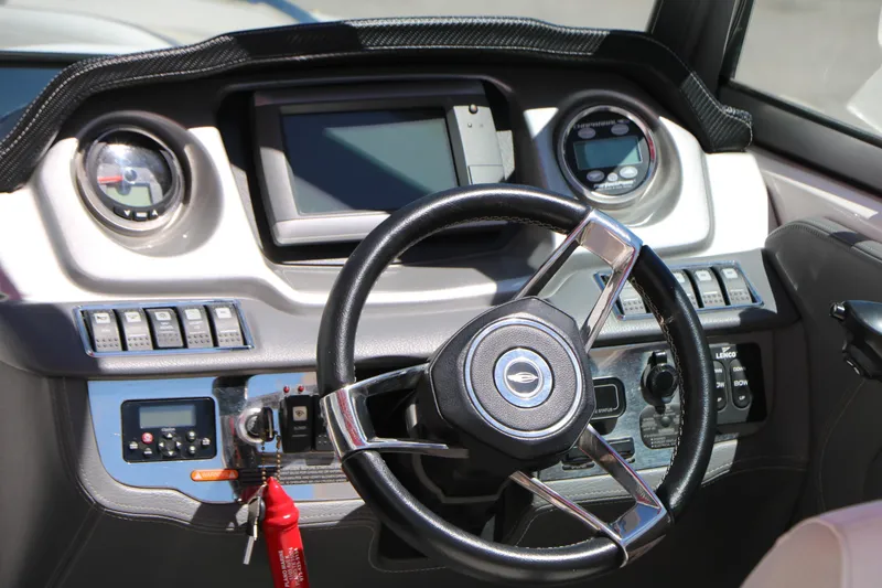 Slide: The Image of Dashboard of a 2014 Chaparral 244 Xtreme boat with steering wheel and controls. - 26