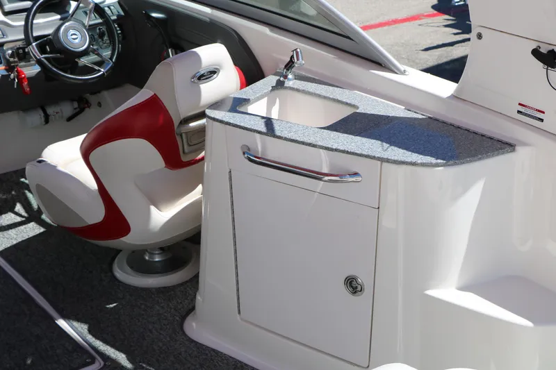 Slide: The Image of Interior of 2014 Chaparral 244 Xtreme boat with steering wheel and sink area. - 27