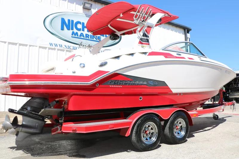 Slide: The Image of 2014 Chaparral 244 Xtreme boat in vibrant red and white, displayed on a trailer. - 3