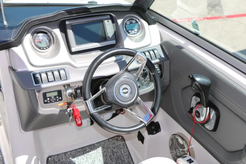 Slide: The Image of 2014 Chaparral 244 Xtreme boat dashboard with steering wheel and control panel. - 30