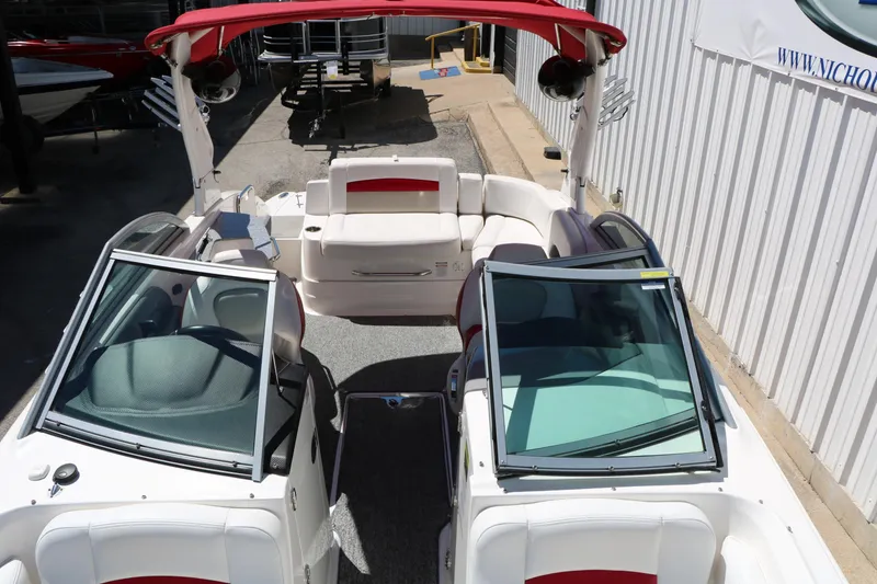 Slide: The Image of 2014 Chaparral 244 Xtreme boat with red canopy and spacious seating. - 35