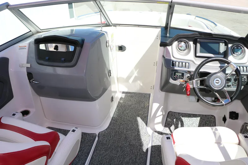 Slide: The Image of Interior view of 2014 Chaparral 244 Xtreme boat cockpit with steering wheel and dashboard controls. - 37