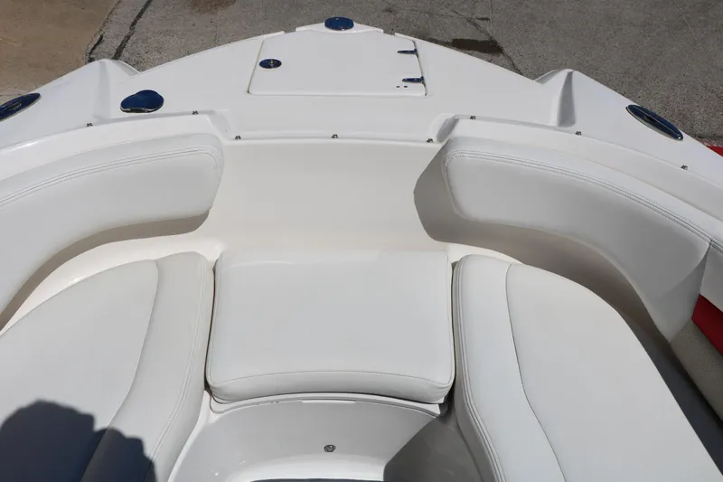 Slide: The Image of 2014 Chaparral 244 Xtreme boat interior with white cushioned seating. - 41