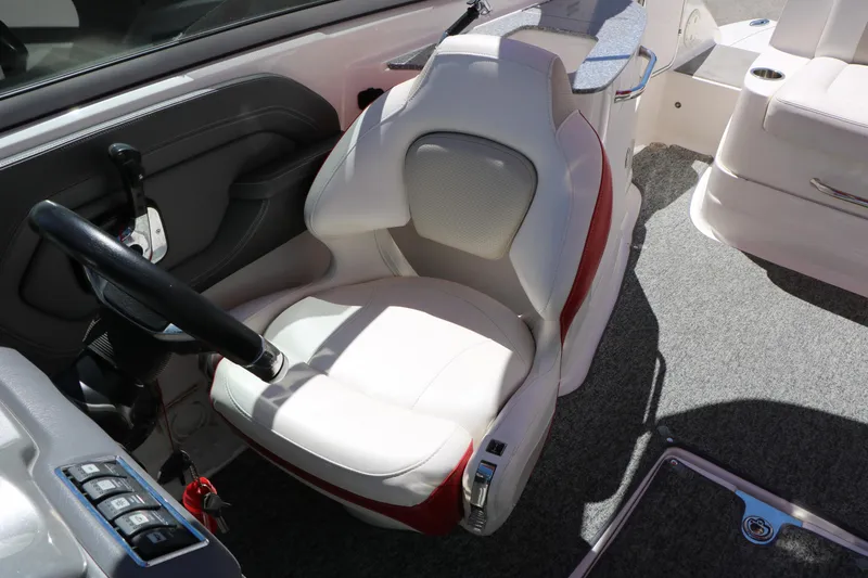 Slide: The Image of 2014 Chaparral 244 Xtreme boat interior with white captain's seat and steering wheel. - 42
