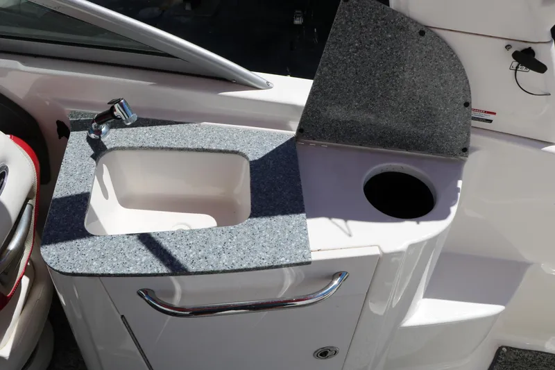 Slide: The Image of 2014 Chaparral 244 Xtreme boat sink with faucet and countertop detail. - 44
