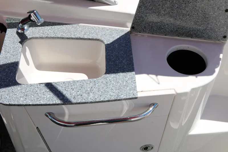 Slide: The Image of 2014 Chaparral 244 Xtreme boat sink with faucet and countertop detail. - 45
