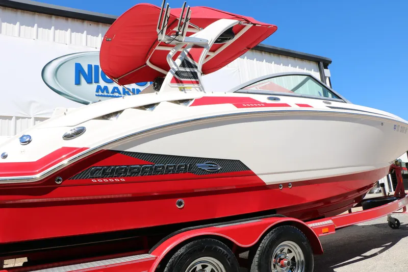 Slide: The Image of 2014 Chaparral 244 Xtreme boat in red and white on trailer, outdoor display. - 5