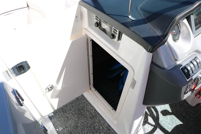 Slide: The Image of 2014 Chaparral 244 Xtreme boat interior storage compartment with open door. - 50