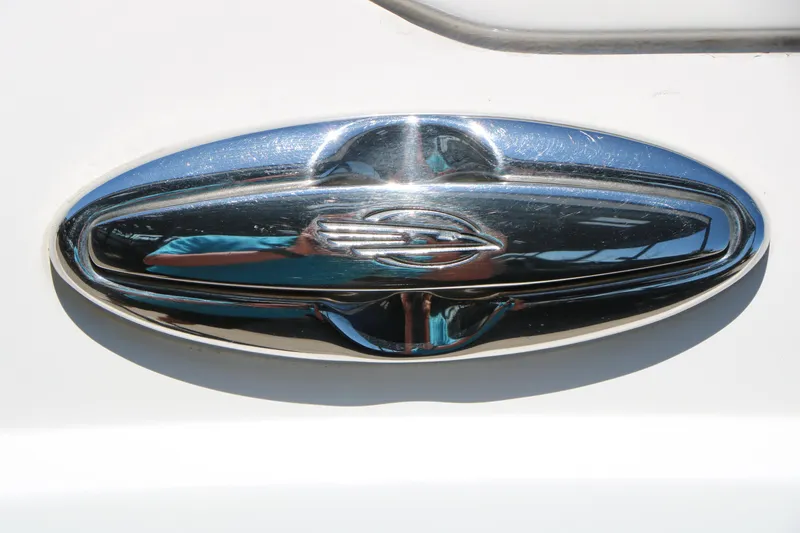 Slide: The Image of Chrome emblem on 2014 Chaparral 244 Xtreme boat, reflecting sunlight. - 53