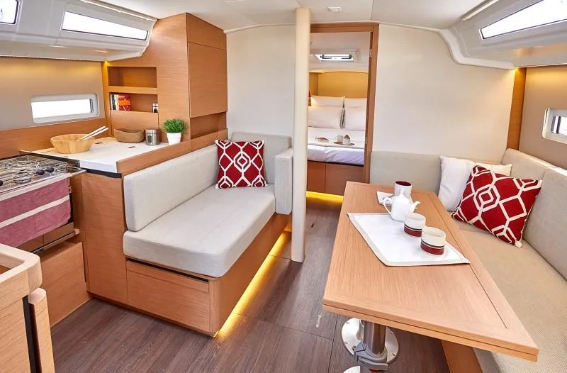 Slide: The Image of 2026 Jeanneau Sun Odyssey 410 interior with modern design, cozy seating, and elegant dining area. - 1