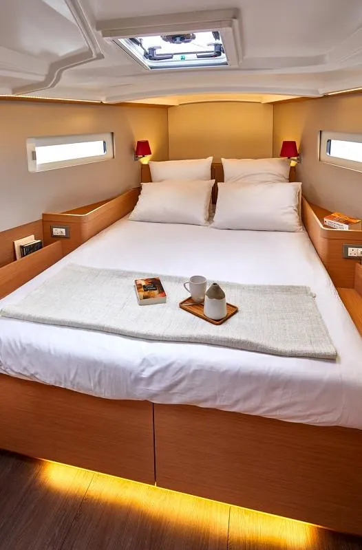 Slide: The Image of Luxurious cabin interior of 2026 Jeanneau Sun Odyssey 410 yacht, featuring cozy bedding and modern design. - 3