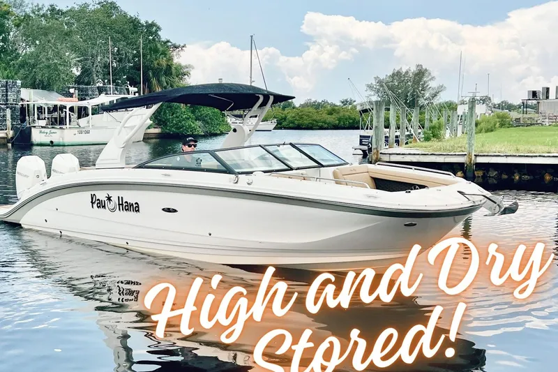 Slide: The Image of 2019 Sea Ray SDX 290 Outboard boat on water, labeled "High and Dry Stored." - 1