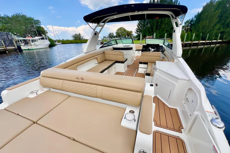 Slide: The Image of 2019 Sea Ray SDX 290 Outboard boat with spacious seating and elegant interior on a calm waterway. - 10