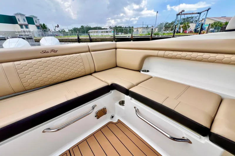 Slide: The Image of 2019 Sea Ray SDX 290 Outboard boat interior with tan leather seating and stainless steel accents. - 14