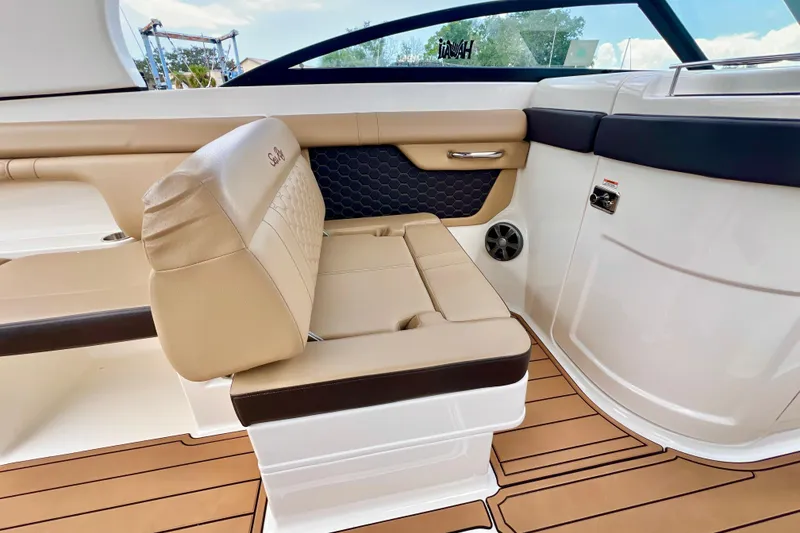 Slide: The Image of 2019 Sea Ray SDX 290 Outboard interior with tan seating and sleek design. - 16