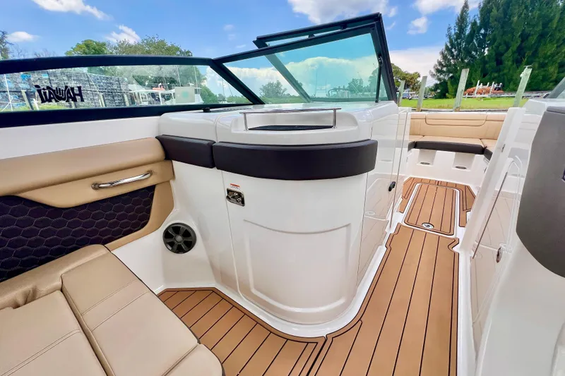 Slide: The Image of 2019 Sea Ray SDX 290 Outboard interior with tan seating and sleek design. - 17