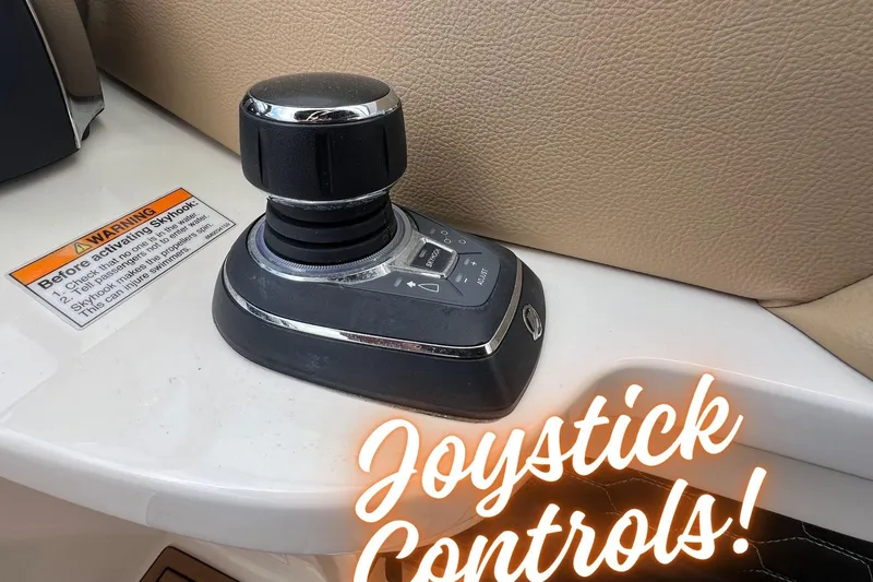 Slide: The Image of Joystick controls on 2019 Sea Ray SDX 290 Outboard boat dashboard. - 2