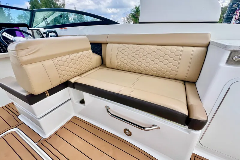 Slide: The Image of 2019 Sea Ray SDX 290 Outboard interior with beige leather seating and modern design. - 20